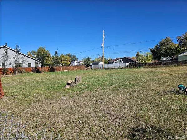 a view of a house with a yard and sitting area