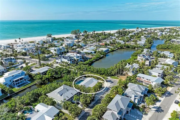 an aerial view of ocean residential houses with outdoor space and swimming pool