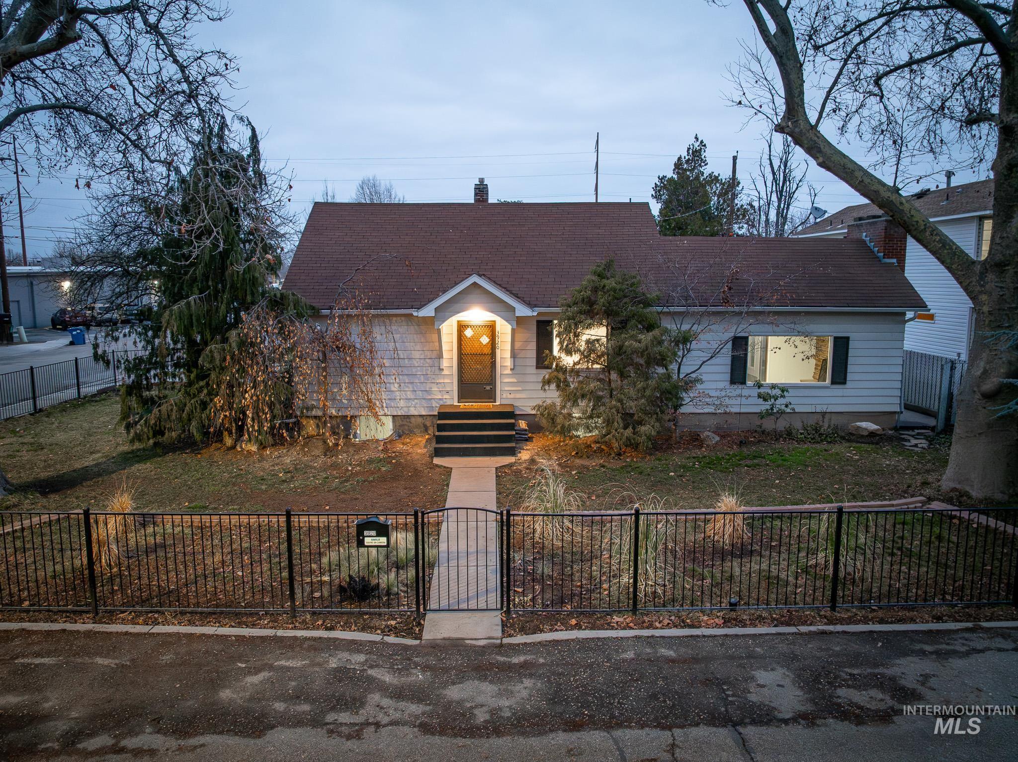 3920 West Dorian Street Boise, ID 83705 - Photo 3 of 4 View of front of property featuring a fenced front yard, a gate, roof with shingles, and a chimney