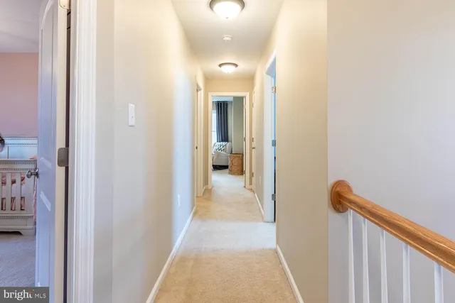 a view of a hallway with closet and wooden floor