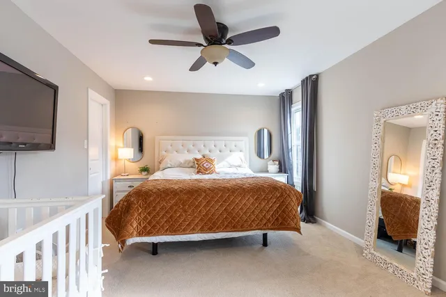 a bedroom with a bed a flat screen tv and dresser