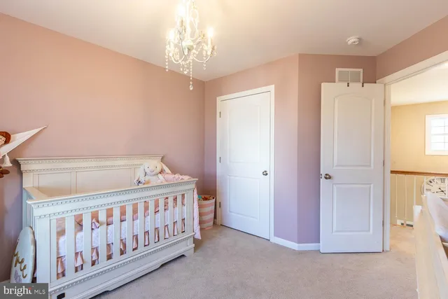 a bedroom with windows and a chandelier