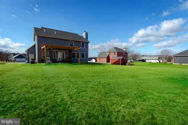 a view of a house with a yard and sitting area