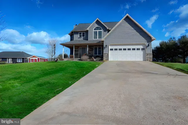 a view of a big house with a big yard and large trees