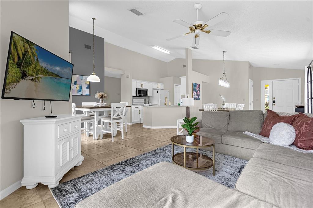 217 Holborn Loop Davenport, FL 33897 - Photo 11 of 23 a living room with furniture kitchen view and a chandelier