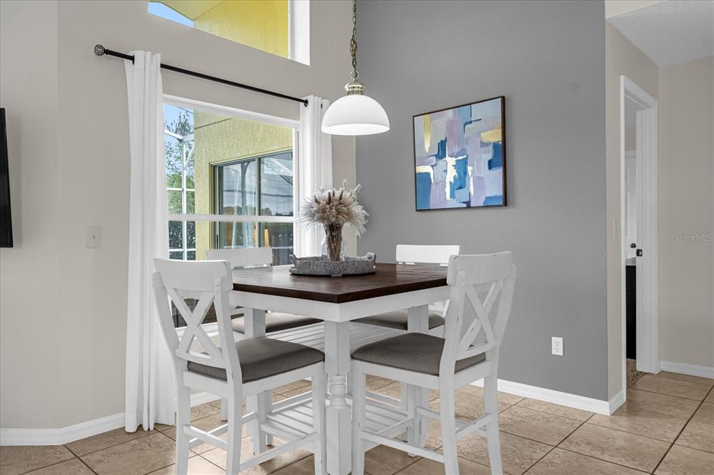217 Holborn Loop Davenport, FL 33897 - Photo 12 of 23 a view of a dining room with furniture and chandelier