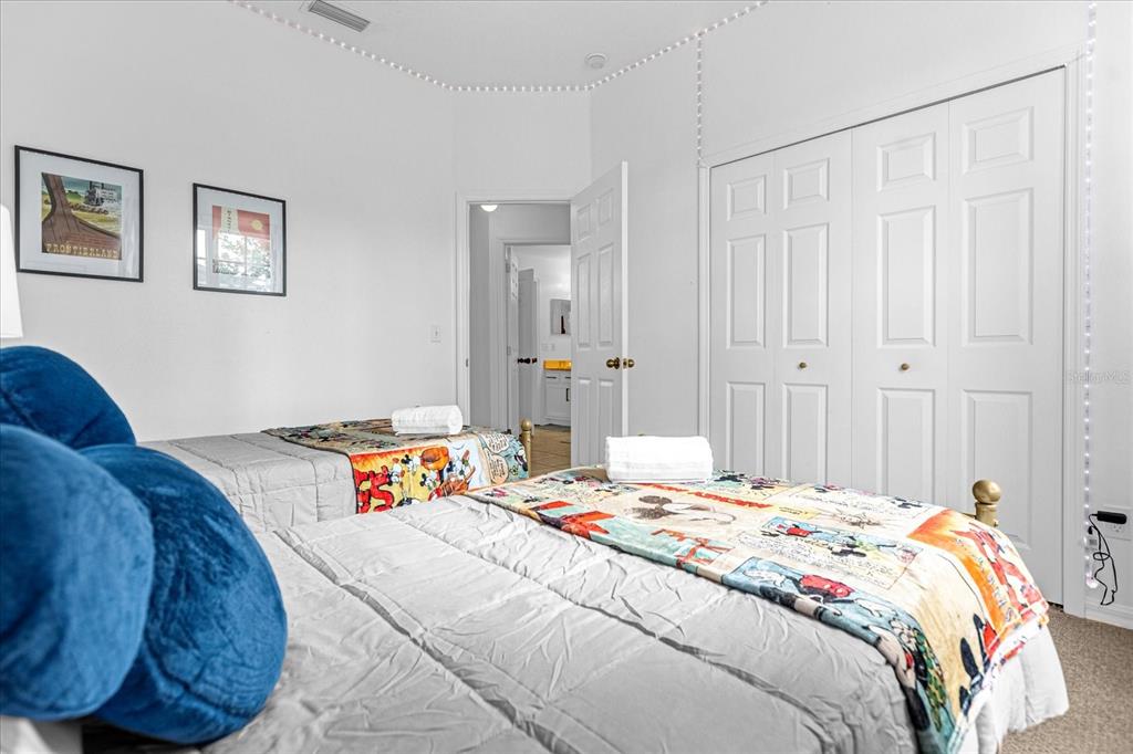 217 Holborn Loop Davenport, FL 33897 - Photo 14 of 23 a bedroom with a bed and a couch