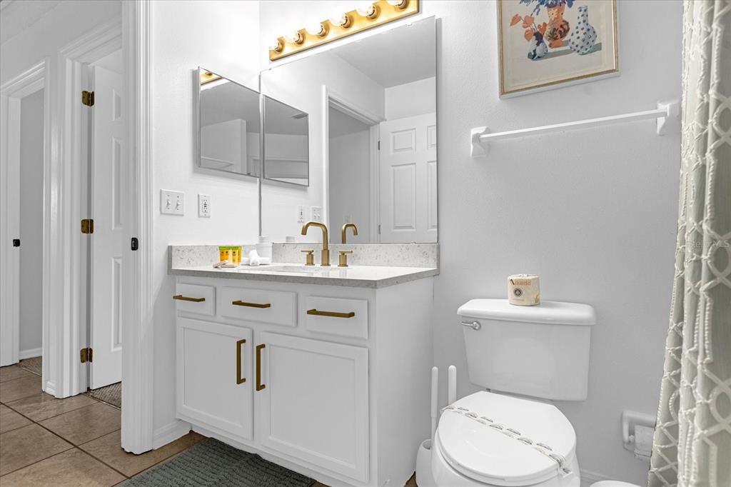 217 Holborn Loop Davenport, FL 33897 - Photo 15 of 23 a bathroom with a toilet sink and mirror