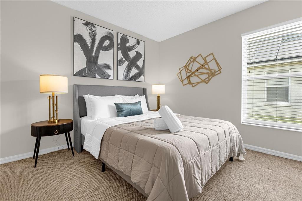 217 Holborn Loop Davenport, FL 33897 - Photo 16 of 23 a bedroom with a bed and a painting on the wall