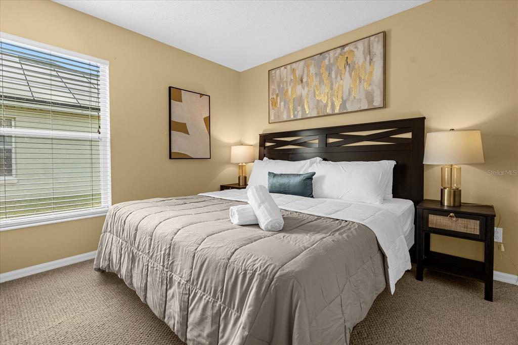 217 Holborn Loop Davenport, FL 33897 - Photo 17 of 23 a bedroom with bed and window