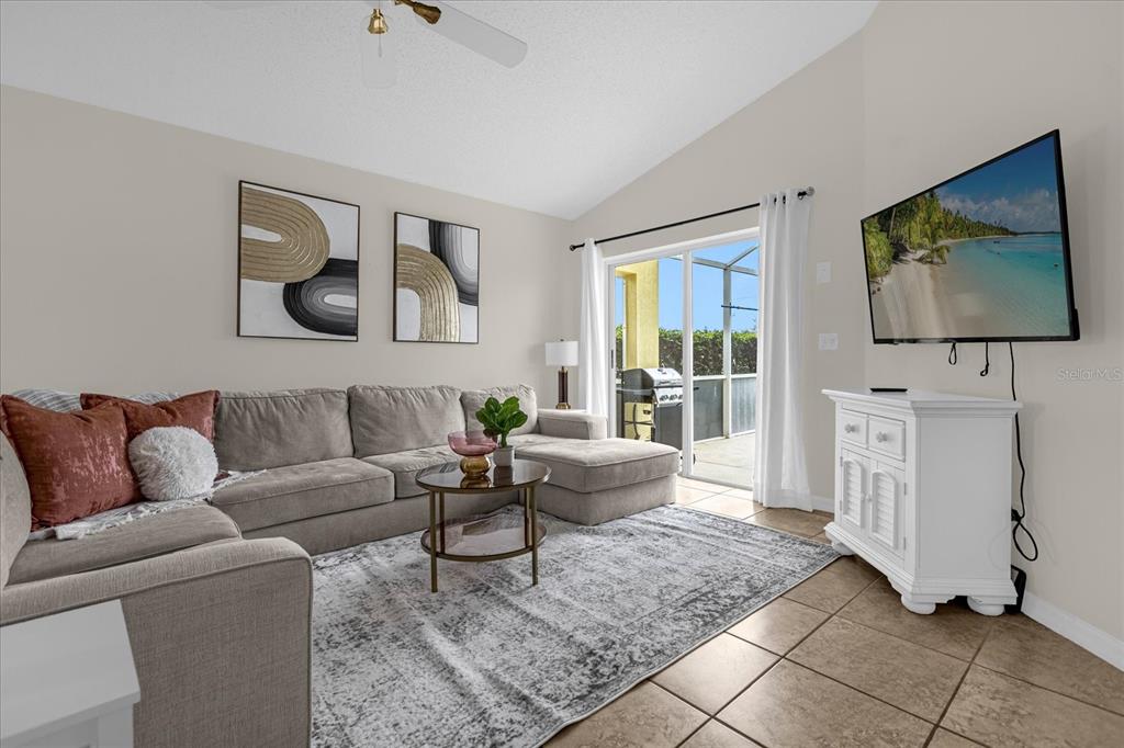 217 Holborn Loop Davenport, FL 33897 - Photo 10 of 23 a living room with furniture and a flat screen tv