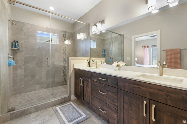 4527 North Seven Bridges Road Eden, UT 84310 - Photo 23 of 65 Full bath with double vanity, a stall shower, and healthy amount of natural light