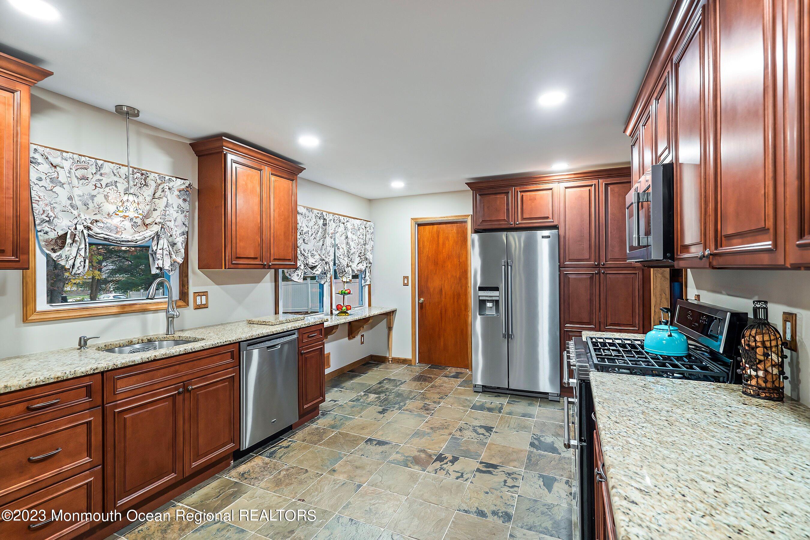 40 South Longview Road Howell, NJ 07731 - Photo 8 of 27 a kitchen with stainless steel appliances granite countertop a refrigerator and a sink
