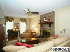 10345 Fairway Ridge Road Charlotte, NC 28277 - Photo 4 of 8 a living room with furniture and a fireplace