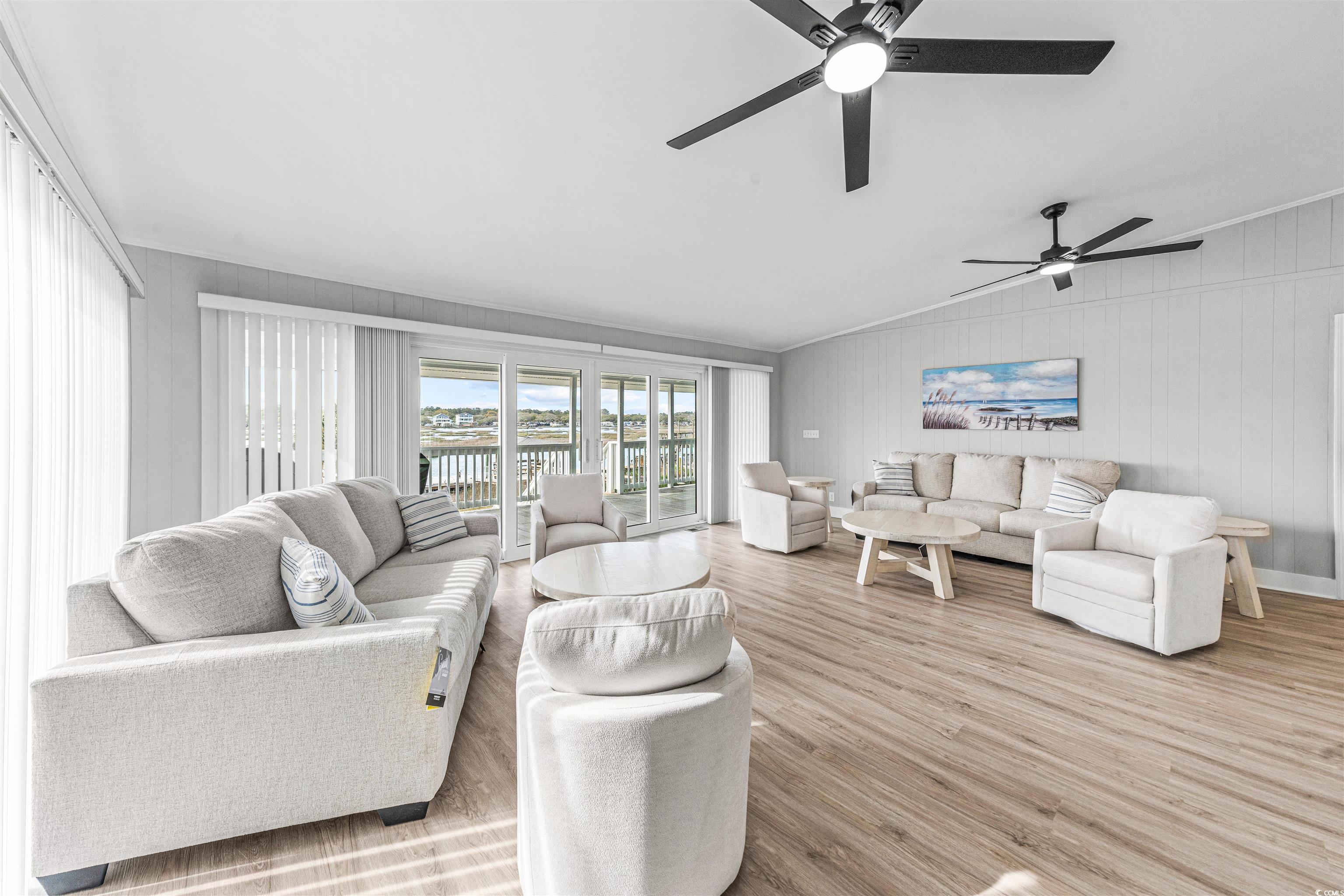 338 State Rd S-26-530 Murrells Inlet, SC 29576 - Photo 18 of 39 Living room with wood finished floors, crown molding, vaulted ceiling, and ceiling fan