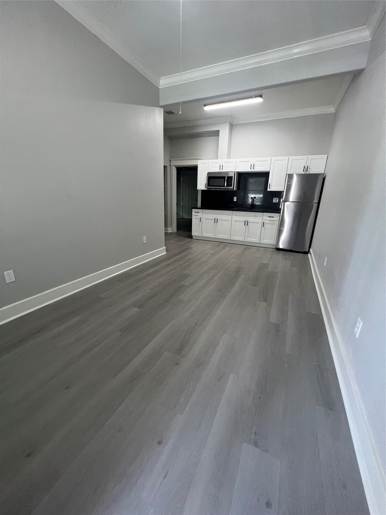 220 Redan Street, Unit A Houston, TX 77009 - Photo 10 of 22 a view of kitchen with furniture and wooden floor