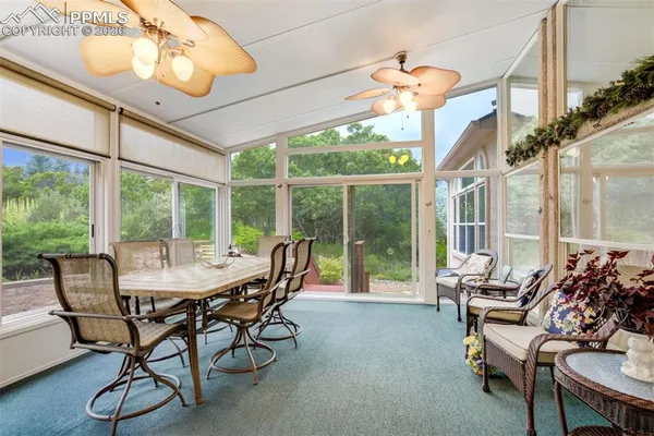 a dining room with furniture water view and a chandelier