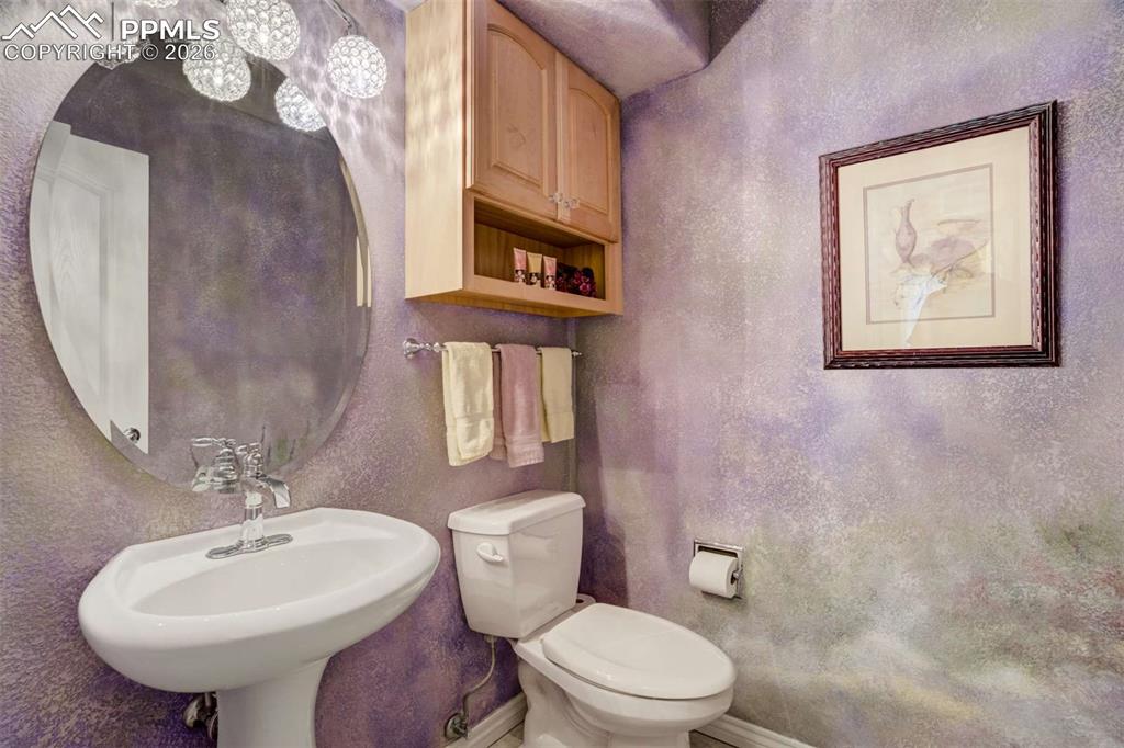 4618 Bethany Court Colorado Springs, CO 80918 - Photo 15 of 50 a bathroom with a toilet a sink and mirror