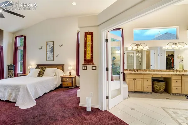 a spacious bedroom with a large bed and a large window