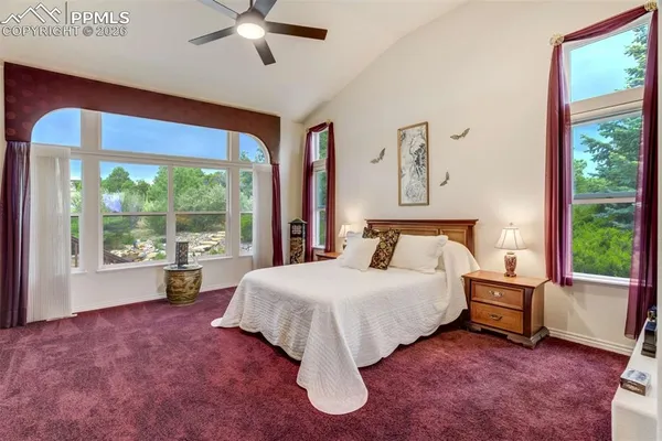 a bedroom with a large bed and a large window