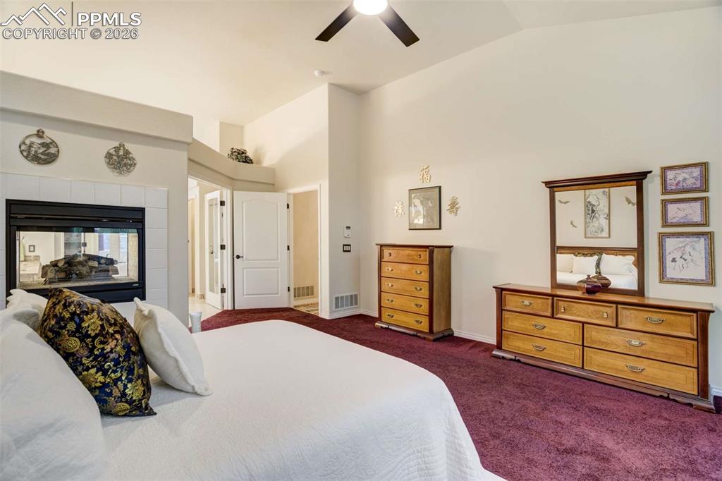 4618 Bethany Court Colorado Springs, CO 80918 - Photo 19 of 50 a bedroom with a large bed and a chandelier