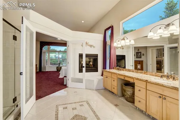 a large white kitchen with a sink and dishwasher with a large window