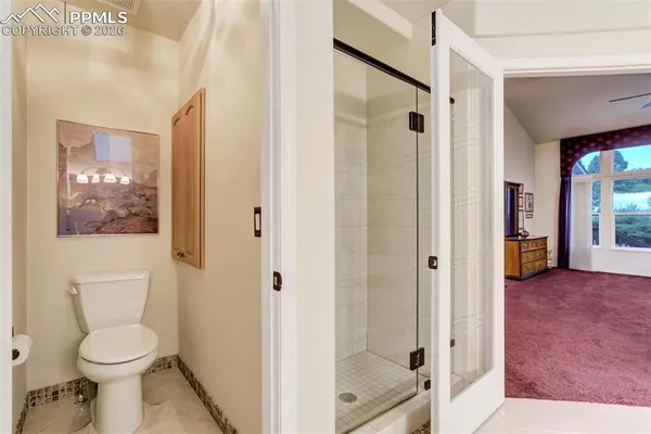 a bathroom with a toilet a sink and shower