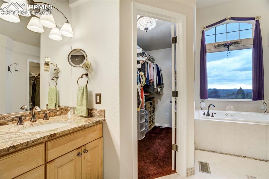 4618 Bethany Court Colorado Springs, CO 80918 - Photo 23 of 50 a bathroom with a tub sink and mirror