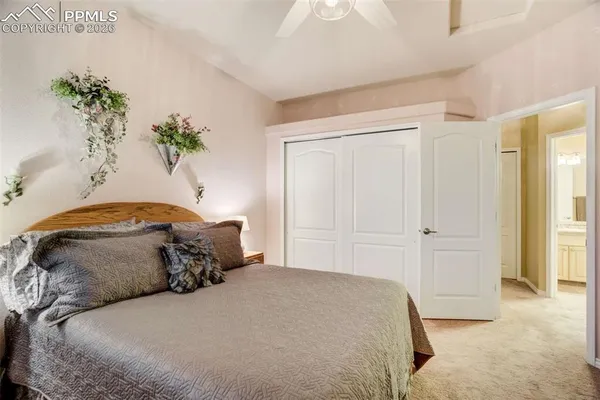 a bedroom with a bed and a potted plant