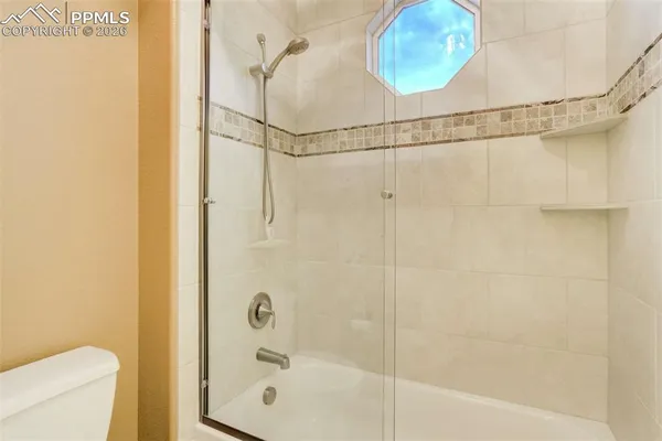 a bathroom with a shower and a toilet