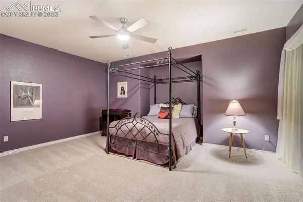 a bedroom with a bed and a lamp