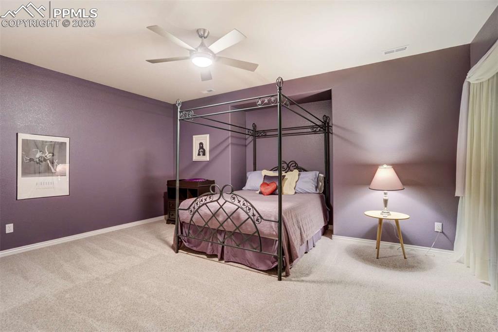 4618 Bethany Court Colorado Springs, CO 80918 - Photo 38 of 50 a bedroom with a bed and a lamp