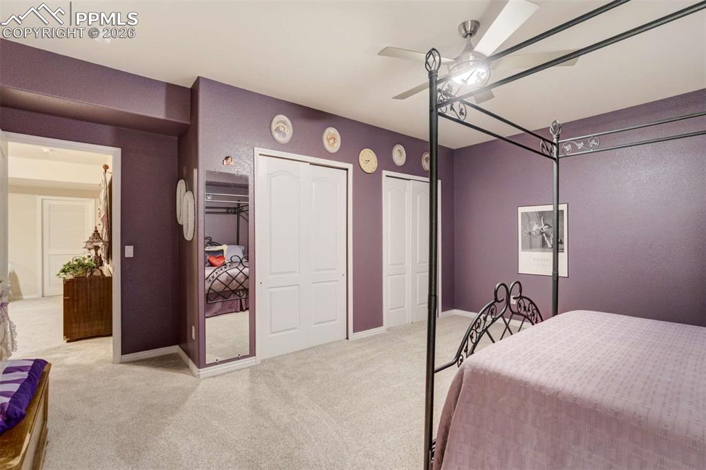 4618 Bethany Court Colorado Springs, CO 80918 - Photo 39 of 50 a bed room with a bed and a chandelier