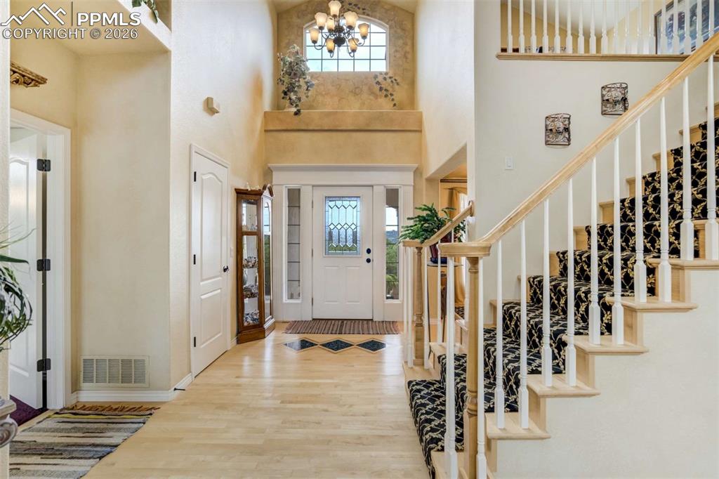 4618 Bethany Court Colorado Springs, CO 80918 - Photo 5 of 50 a view of an entryway with wooden floor and stairs