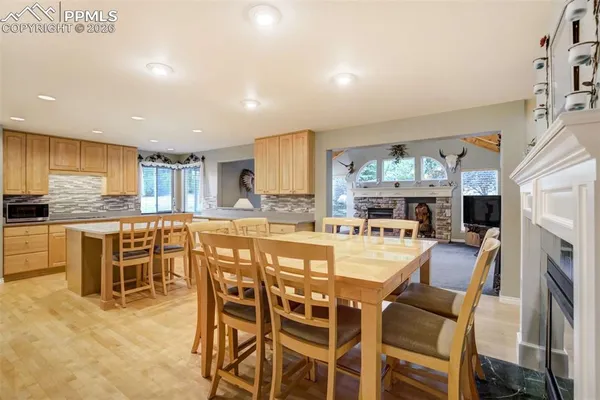 a large kitchen with a table and chairs