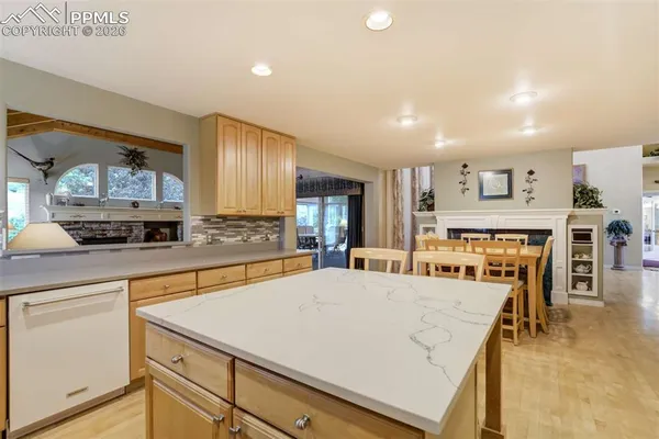a large kitchen with cabinets table and chairs