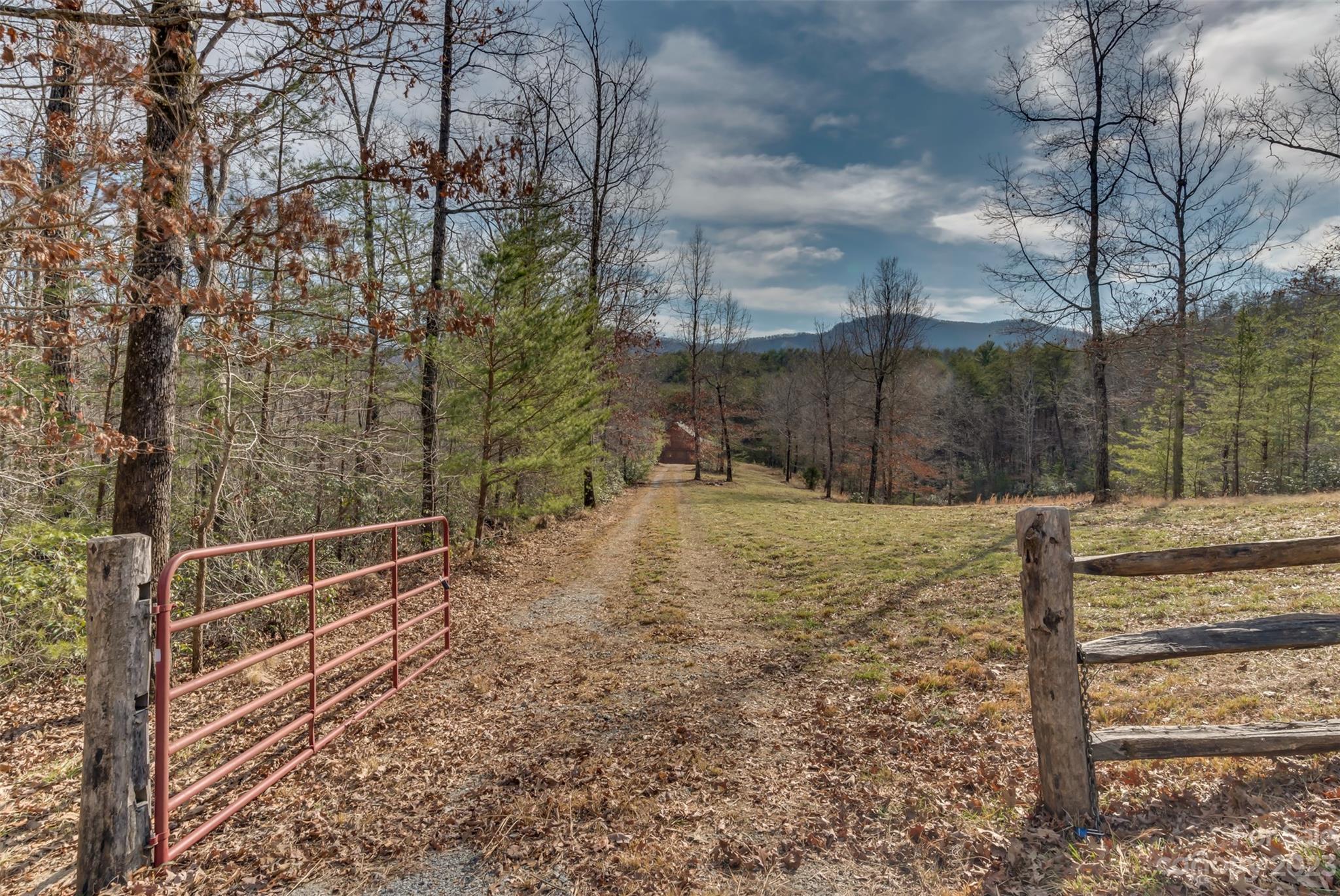 Tbd Sloping Meadow Mill Spring, NC 28756 - Photo 1 of 16 a view of a yard with wooden fence