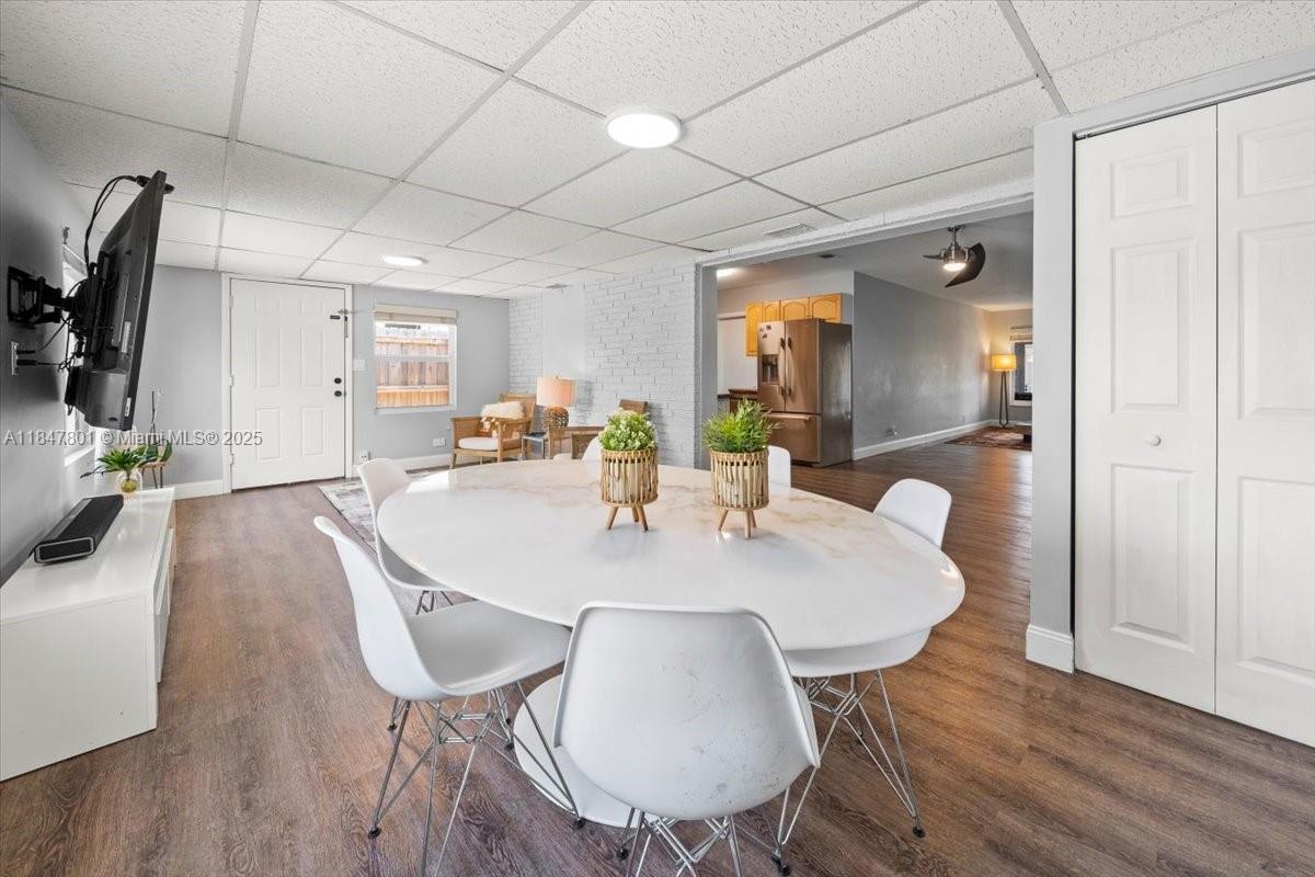 3751 Northeast 16th Avenue Pompano Beach, FL 33064 - Photo 12 of 41 a view of a dining room with furniture and wooden floor