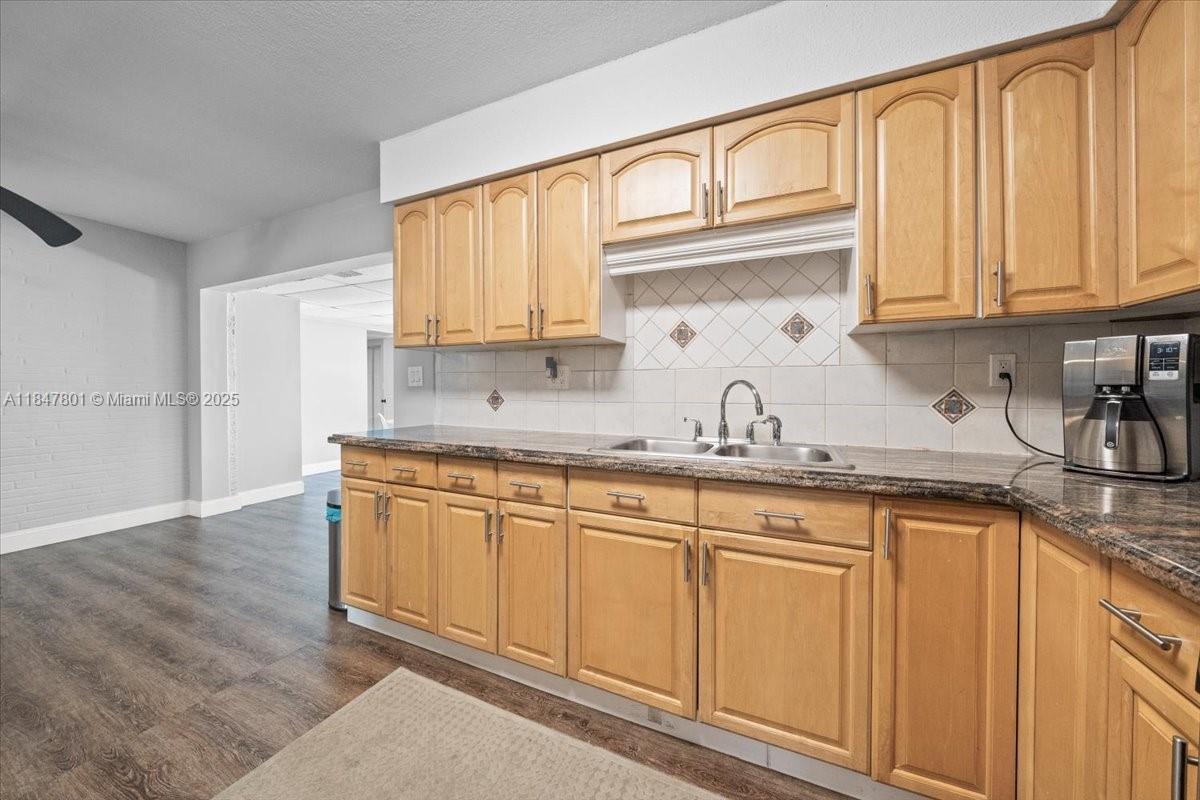 3751 Northeast 16th Avenue Pompano Beach, FL 33064 - Photo 15 of 41 a kitchen with granite countertop white cabinets and sink