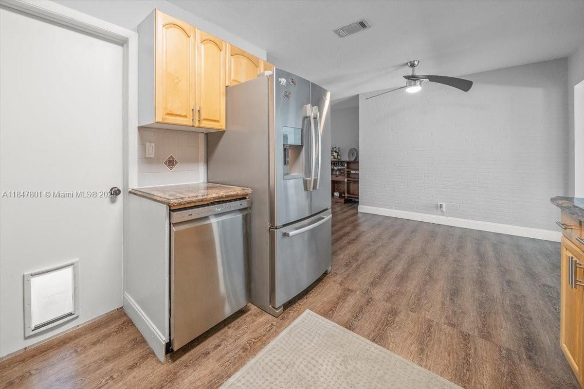 3751 Northeast 16th Avenue Pompano Beach, FL 33064 - Photo 16 of 41 a kitchen with stainless steel appliances a refrigerator and a stove top oven