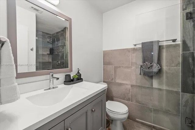 a bathroom with a sink toilet and shower