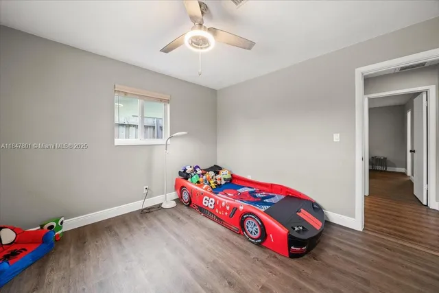 a bedroom with bed and a chandelier