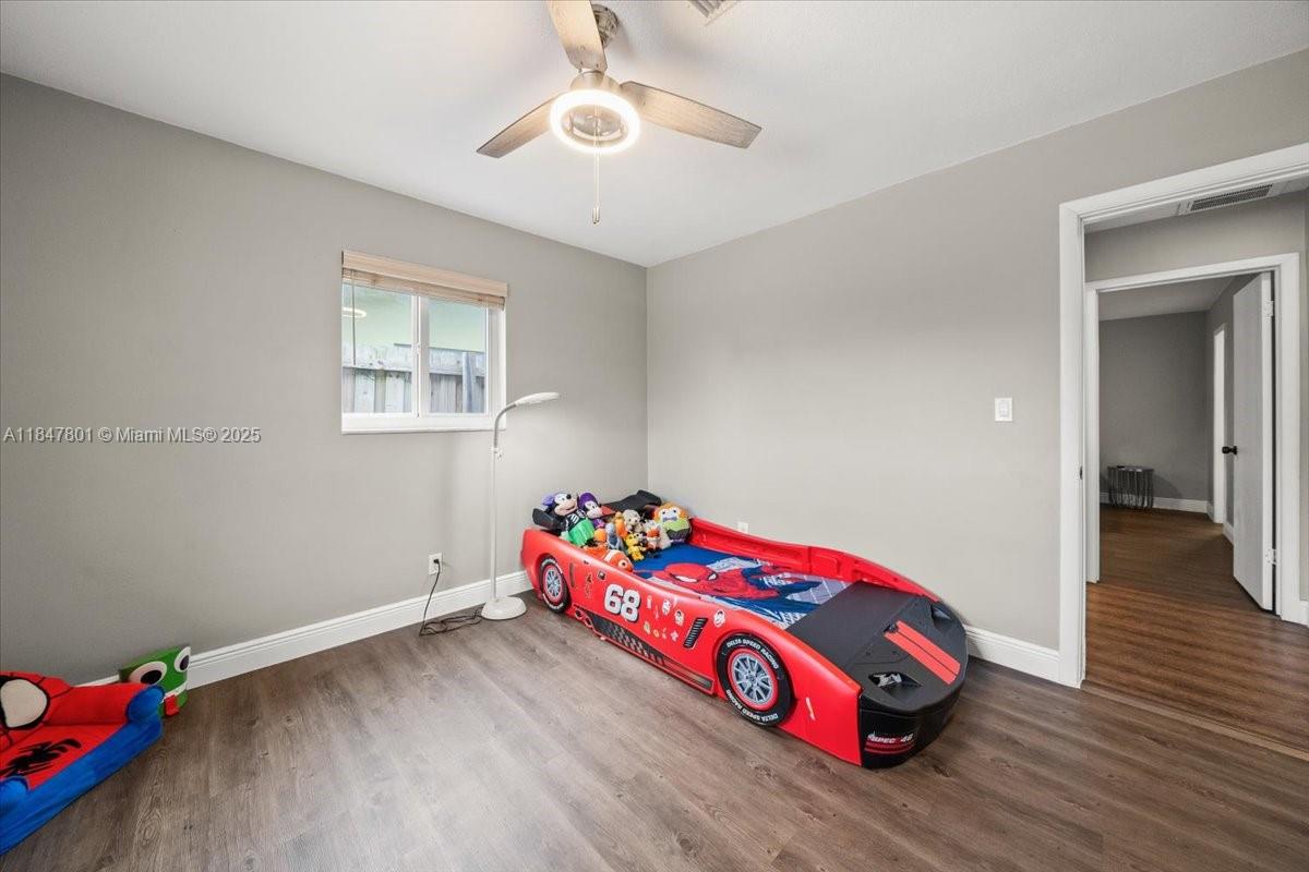 3751 Northeast 16th Avenue Pompano Beach, FL 33064 - Photo 22 of 41 a bedroom with bed and a chandelier