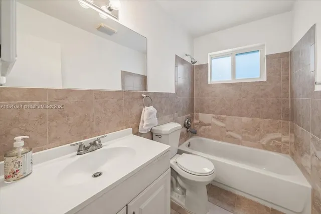 a bathroom with a sink a toilet and bathtub