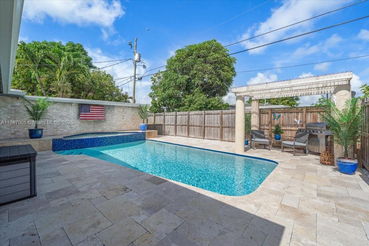 3751 Northeast 16th Avenue Pompano Beach, FL 33064 - Photo 27 of 41 a view of backyard with swimming pool and seating space