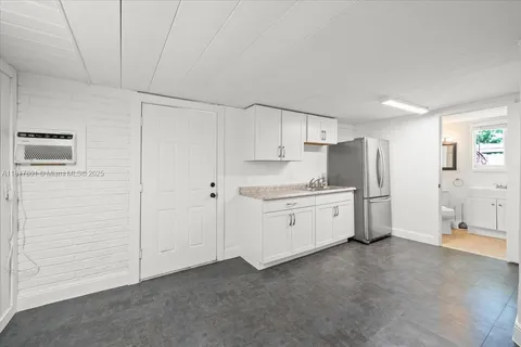 a kitchen with white cabinets and white appliances