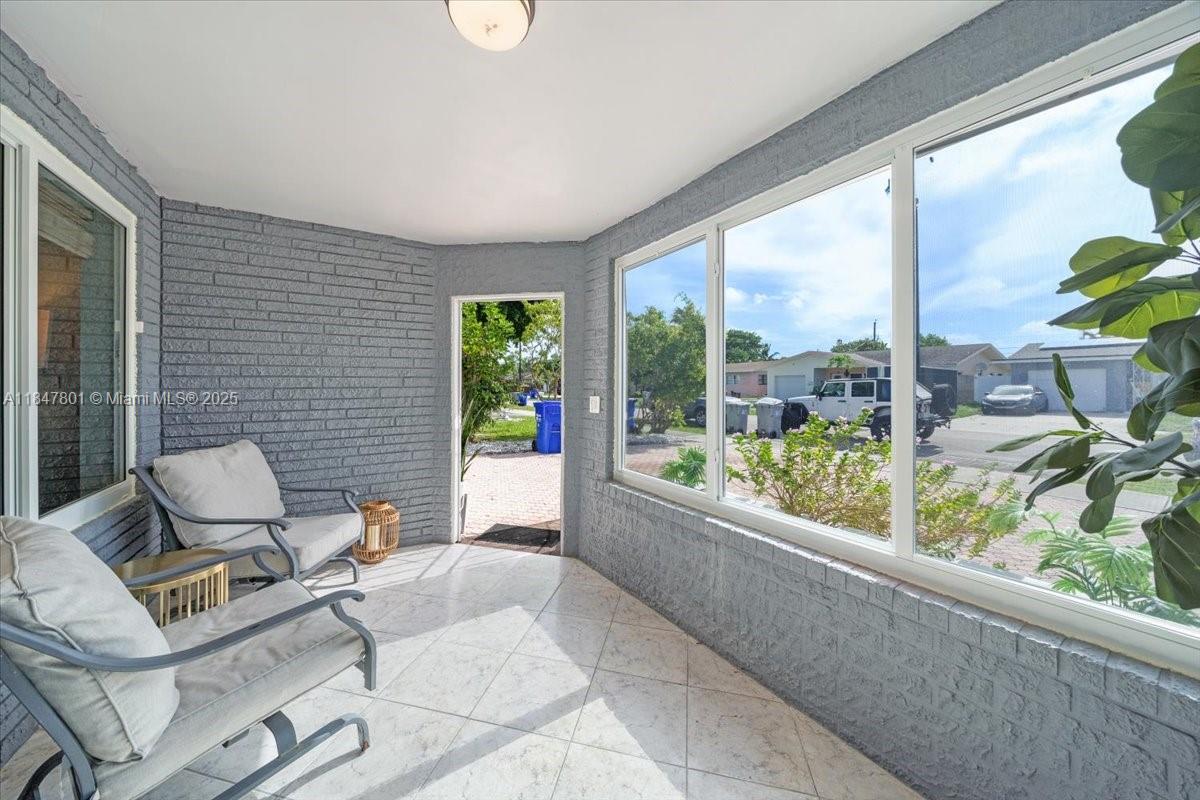 3751 Northeast 16th Avenue Pompano Beach, FL 33064 - Photo 3 of 41 a living room with furniture and a large window