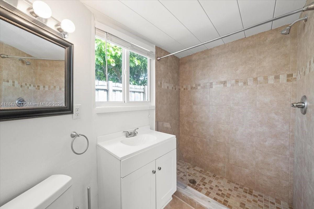 3751 Northeast 16th Avenue Pompano Beach, FL 33064 - Photo 32 of 41 a bathroom with a sink toilet and tub