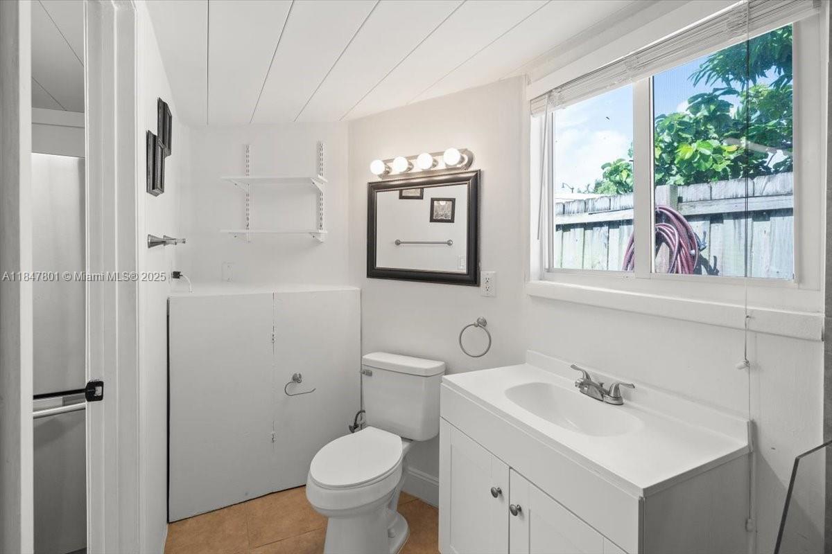 3751 Northeast 16th Avenue Pompano Beach, FL 33064 - Photo 33 of 41 a bathroom with a toilet sink and mirror