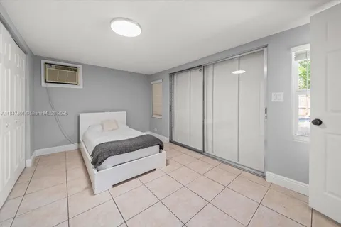 a spacious bedroom with a bed and a shower